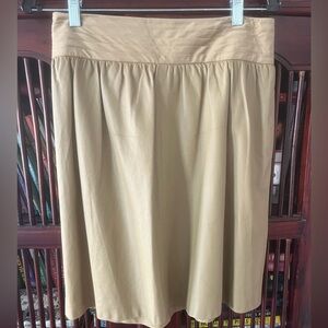 Etcetera tan buttery leather skirt. 2 2/4” pleated waist. 18 1/4 “ skirt length.
